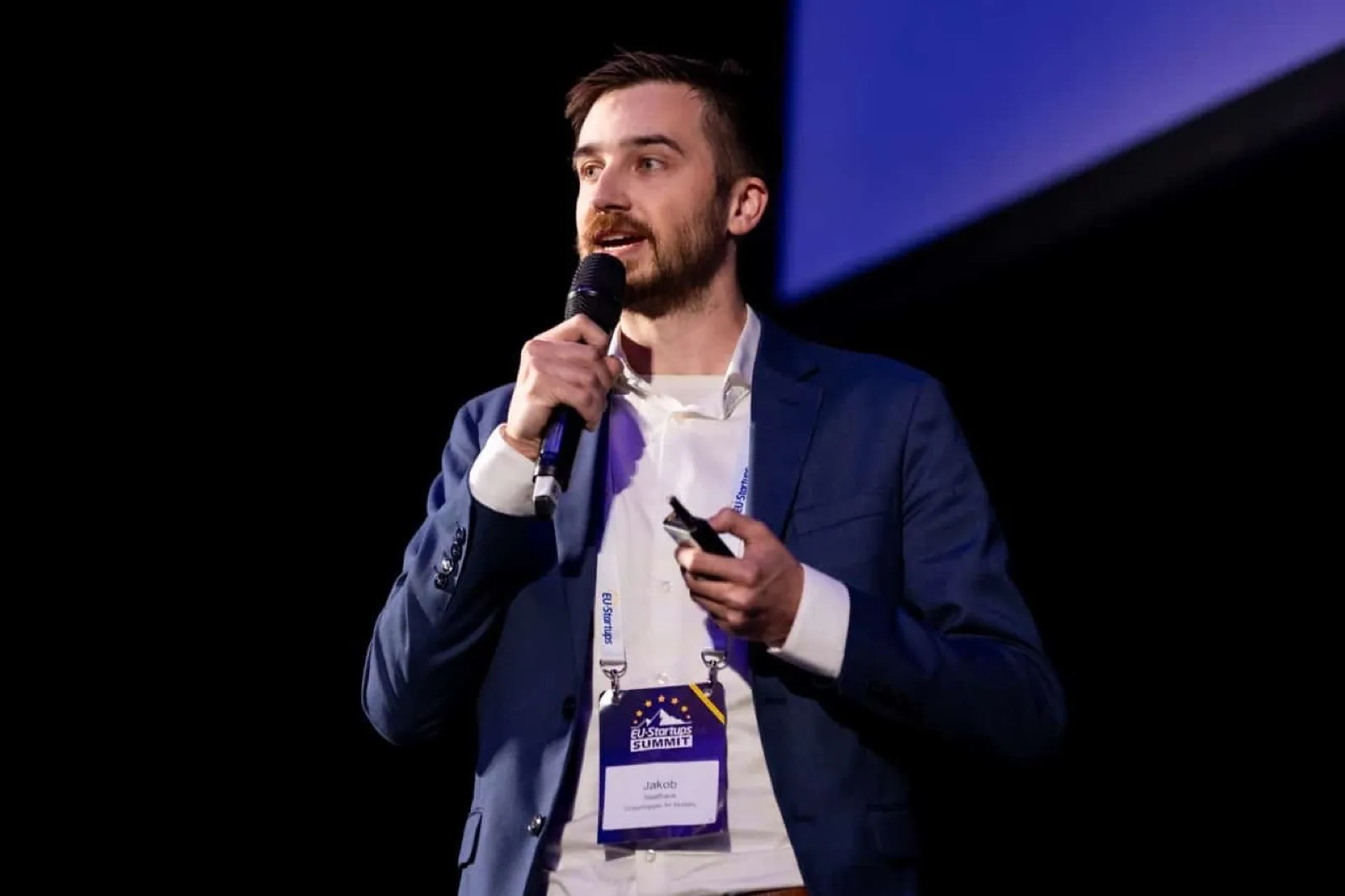Jakob presentando con micrófono en la final de pitches de la EU-Startups Summit en Malta, abril de 2025.
